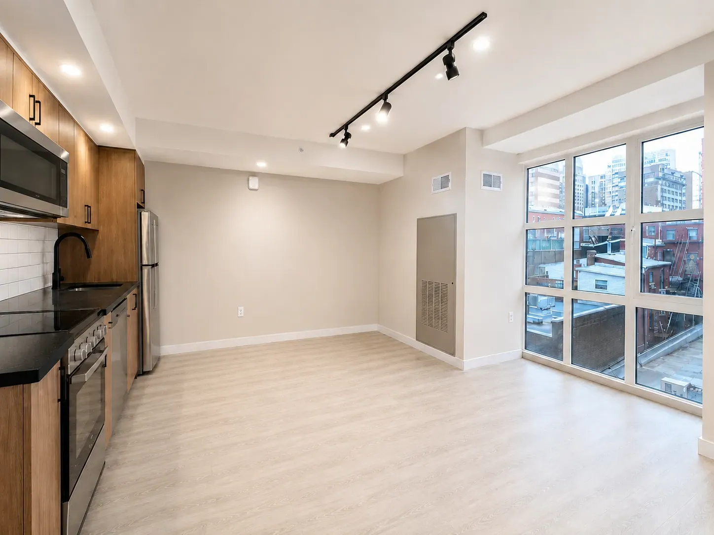 Studio residence with a warm, dark finish palette at The Ranstead